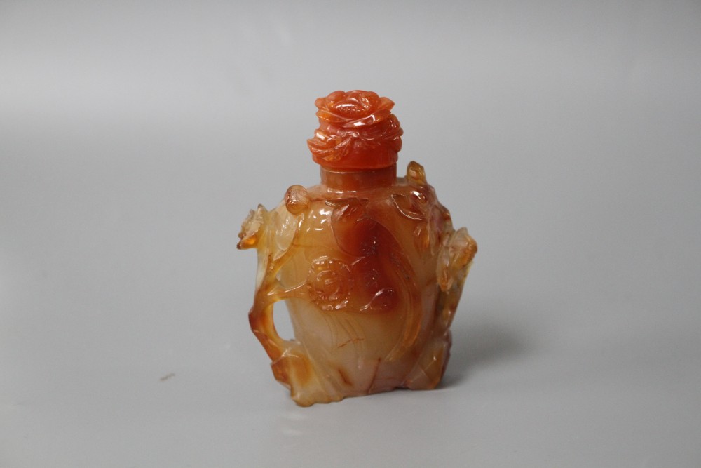 A Chinese orange agate snuff bottle and stopper, carved in relief with birds and flowers, width 6cm, height 8.5cm